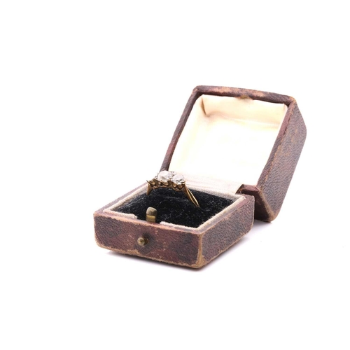 28 - A diamond three stone ring, set with a central cushion shape old cut diamond between round old cut d... 