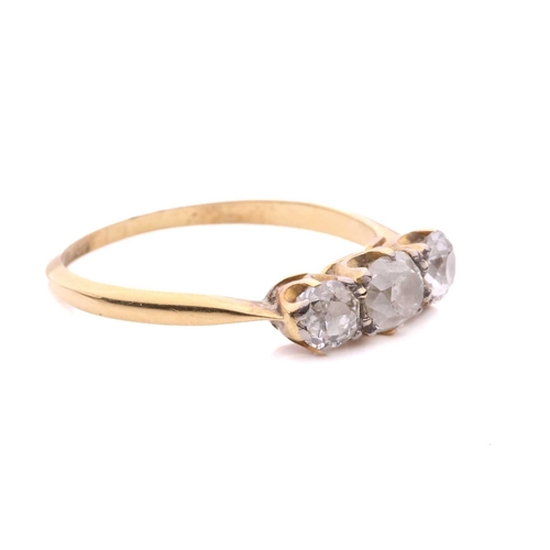 28 - A diamond three stone ring, set with a central cushion shape old cut diamond between round old cut d... 