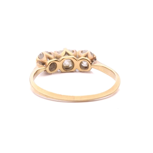 28 - A diamond three stone ring, set with a central cushion shape old cut diamond between round old cut d... 