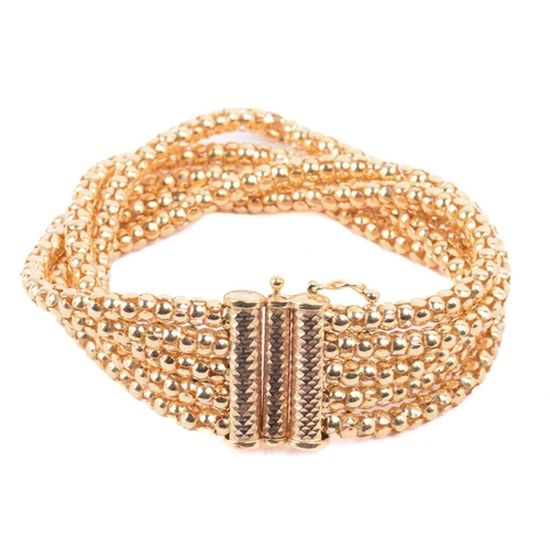 281 - A popcorn link bracelet in 9ct yellow gold, comprising five rows of popcorn links, fastened with a f... 