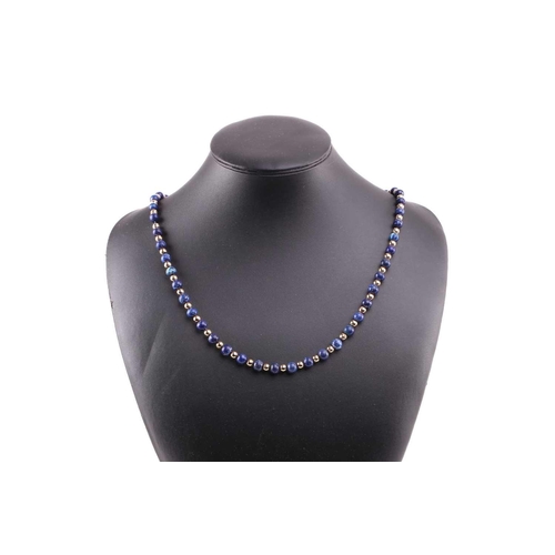 293 - A bead necklace with alternate sodalite and yellow metal graduated beads, to a clasp stamped '9ct', ... 