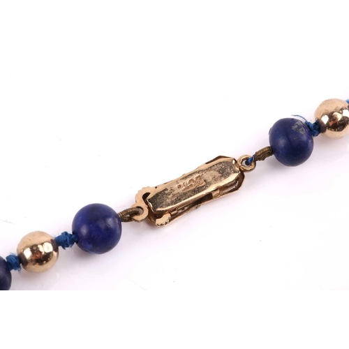 293 - A bead necklace with alternate sodalite and yellow metal graduated beads, to a clasp stamped '9ct', ... 