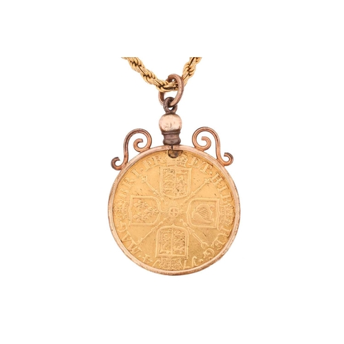 294 - A Queen Anne gold guinea in mount and an associated chain, the coin dated 1714, obverse with third d... 