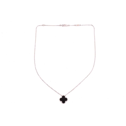 299 - Van Cleef & Arpels - an 18ct white gold and onyx 'Alhambra' pendant on chain, comprising the iconic ... 