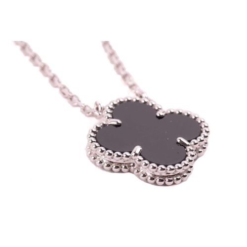299 - Van Cleef & Arpels - an 18ct white gold and onyx 'Alhambra' pendant on chain, comprising the iconic ... 