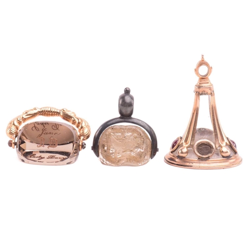 3 - A group of three 19th-century seal fobs; including a rock crystal three-sided swivel fob seal, one o... 