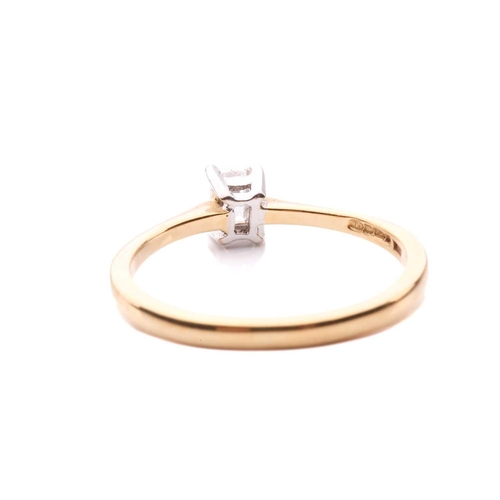 31 - A diamond solitaire ring and a crucifix pendant; the 18ct gold ring centred with an emerald-cut diam... 
