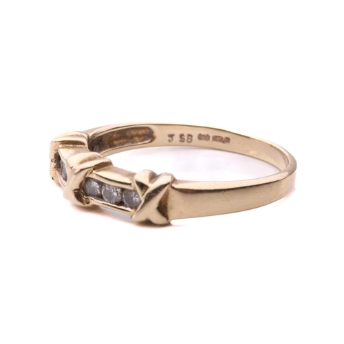 32 - A channel-set diamond ring in 14ct yellow gold, comprising three cross-lashing motifs, flanked by ro... 