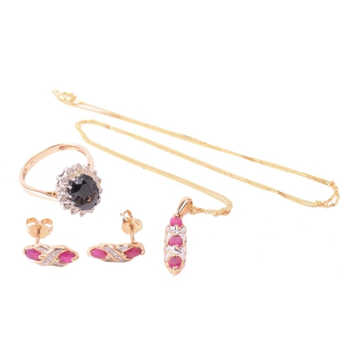 33 - A ruby necklace and earrings ensuite together with a dress ring; the pendant set with three oval-cut... 