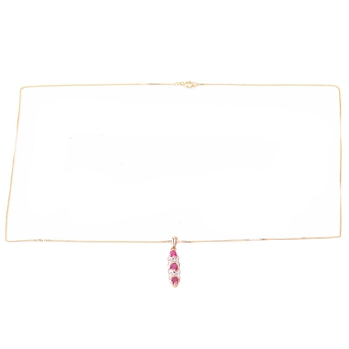 33 - A ruby necklace and earrings ensuite together with a dress ring; the pendant set with three oval-cut... 