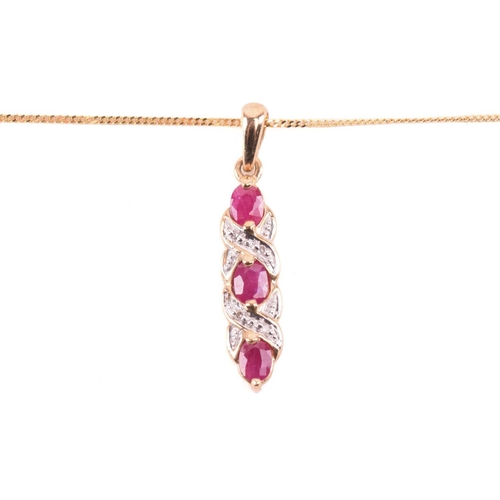 33 - A ruby necklace and earrings ensuite together with a dress ring; the pendant set with three oval-cut... 