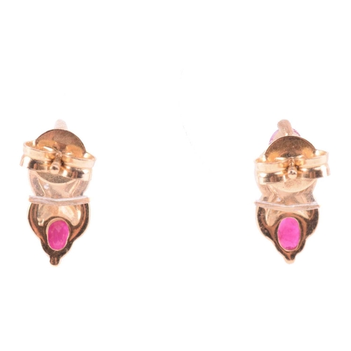 33 - A ruby necklace and earrings ensuite together with a dress ring; the pendant set with three oval-cut... 