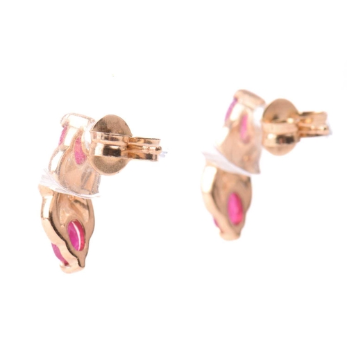 33 - A ruby necklace and earrings ensuite together with a dress ring; the pendant set with three oval-cut... 