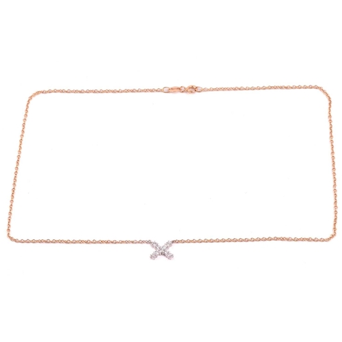 34 - A diamond kiss pendant, set with round brilliant cut diamonds with a total estimated weight of 0.30c... 