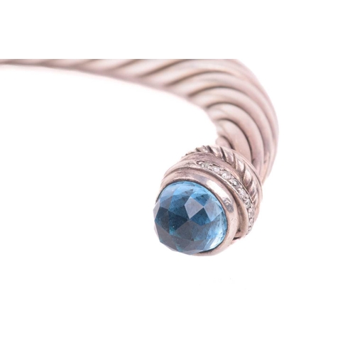 35 - A gem-set torque bangle by David Yurman, composed of twisted cables, terminating with diamond-set ro... 