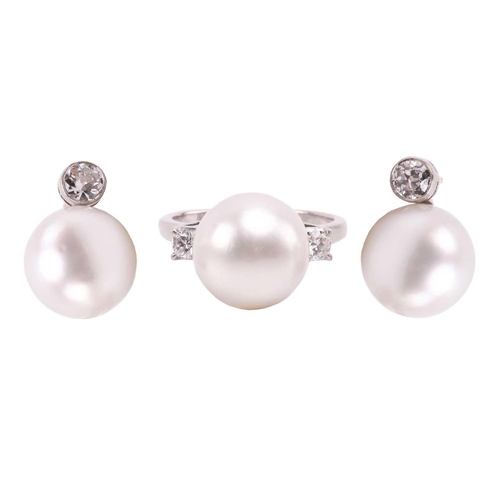 36 - A pair of pearl and diamond earrings and a ring en suite; the central single freshwater pearl flanke... 