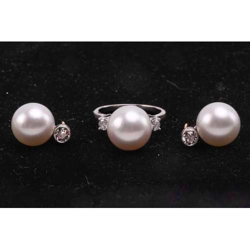 36 - A pair of pearl and diamond earrings and a ring en suite; the central single freshwater pearl flanke... 