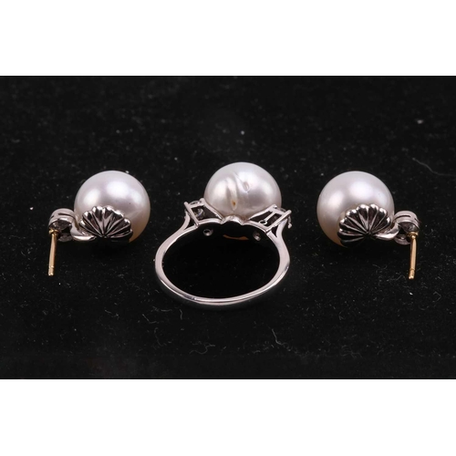 36 - A pair of pearl and diamond earrings and a ring en suite; the central single freshwater pearl flanke... 