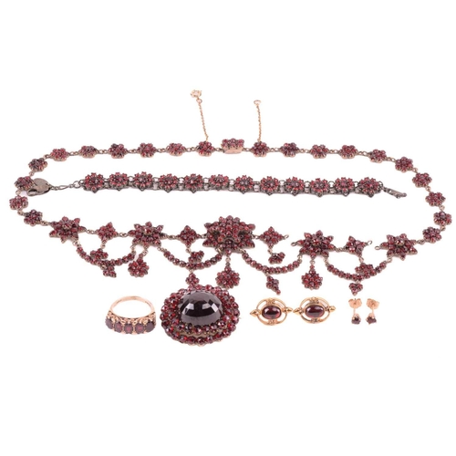 38 - A Victorian Bohemian garnet necklace, set with clusters and swags of garnets, with a length of 47cm,... 
