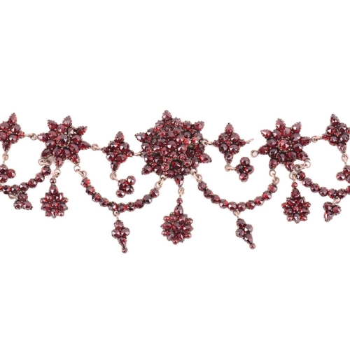 38 - A Victorian Bohemian garnet necklace, set with clusters and swags of garnets, with a length of 47cm,... 