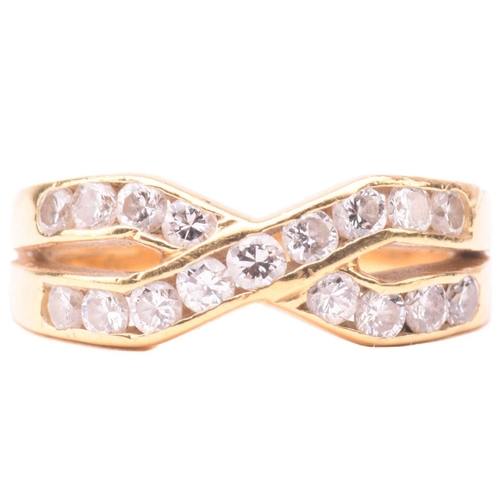 41 - A diamond cross over ring, set with two rows of round brilliant cut diamonds in a channel setting, w... 