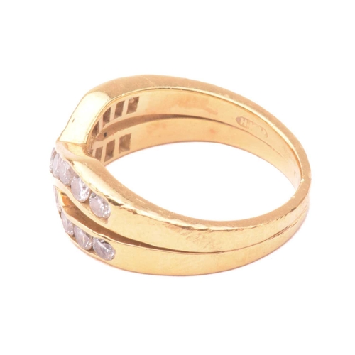 41 - A diamond cross over ring, set with two rows of round brilliant cut diamonds in a channel setting, w... 
