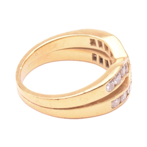 41 - A diamond cross over ring, set with two rows of round brilliant cut diamonds in a channel setting, w... 