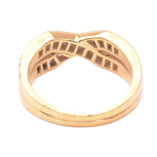 41 - A diamond cross over ring, set with two rows of round brilliant cut diamonds in a channel setting, w... 