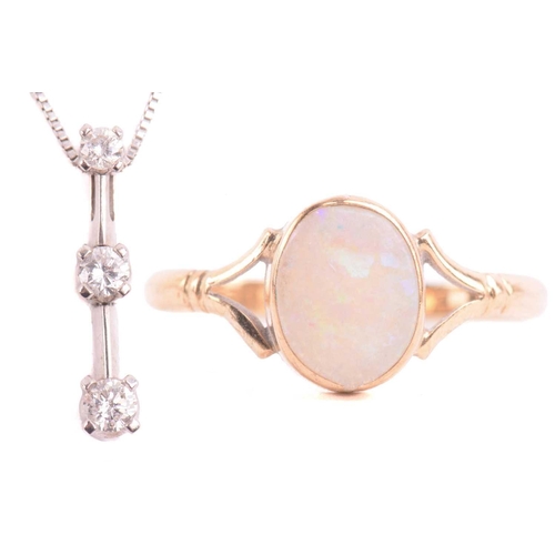 42 - An opal dress ring in 9ct gold and a diamond pendant on chain; the ring contains an oval cabochon of... 