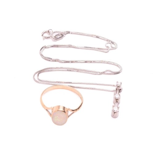 42 - An opal dress ring in 9ct gold and a diamond pendant on chain; the ring contains an oval cabochon of... 