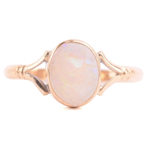 42 - An opal dress ring in 9ct gold and a diamond pendant on chain; the ring contains an oval cabochon of... 