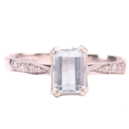 43 - An aquamarine and diamond ring, set with an emerald cut aquamarine measuring 7mm x 5.2mm, the should... 