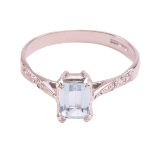 43 - An aquamarine and diamond ring, set with an emerald cut aquamarine measuring 7mm x 5.2mm, the should... 