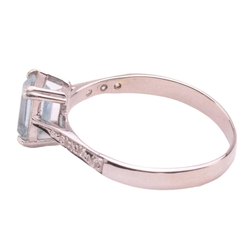 43 - An aquamarine and diamond ring, set with an emerald cut aquamarine measuring 7mm x 5.2mm, the should... 