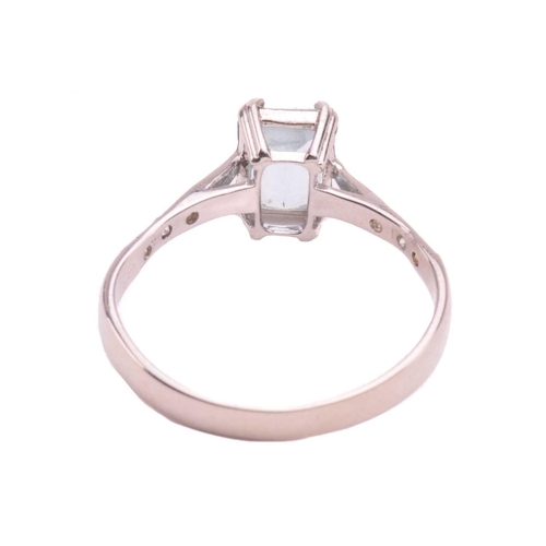 43 - An aquamarine and diamond ring, set with an emerald cut aquamarine measuring 7mm x 5.2mm, the should... 