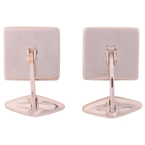 44 - A pair of square cufflinks, the bevelled head centred with a brushed finish panel, framed with a Gre... 