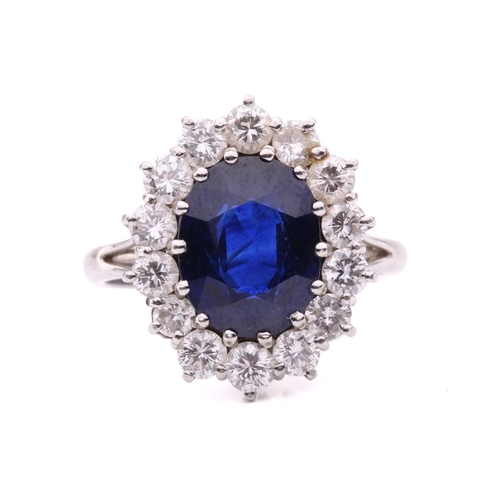46 - A sapphire and diamond cluster ring, set to the centre with an oval sapphire measuring 11.1 x 8.7 x ... 