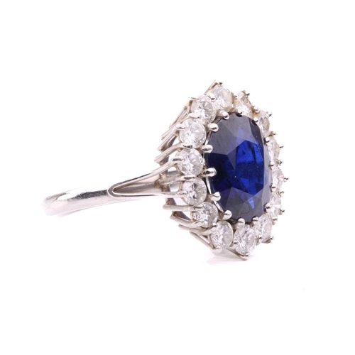 46 - A sapphire and diamond cluster ring, set to the centre with an oval sapphire measuring 11.1 x 8.7 x ... 