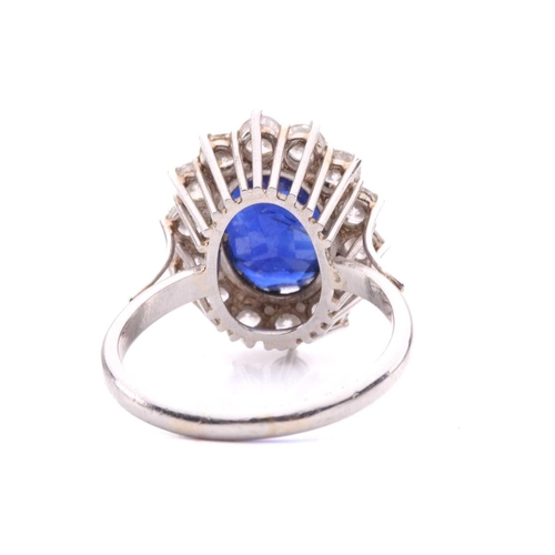 46 - A sapphire and diamond cluster ring, set to the centre with an oval sapphire measuring 11.1 x 8.7 x ... 