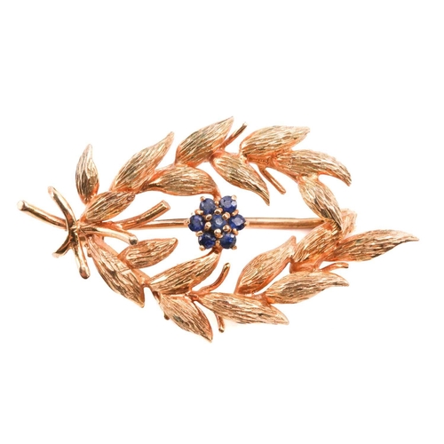47 - A gold and sapphire spray brooch by Cropp & Farr, designed as a spray of foliage with a sapphire clu... 