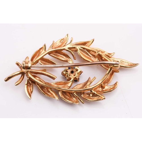 47 - A gold and sapphire spray brooch by Cropp & Farr, designed as a spray of foliage with a sapphire clu... 