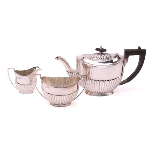 484 - A George IV-style three-piece silver tea set, with makers mark A W | J H, Sheffield 1921, of oval fo... 