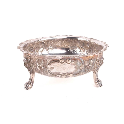 489 - A Victorian silver bowl decorated with flowers and C scrolls around a vacant cartouche, with a beade... 