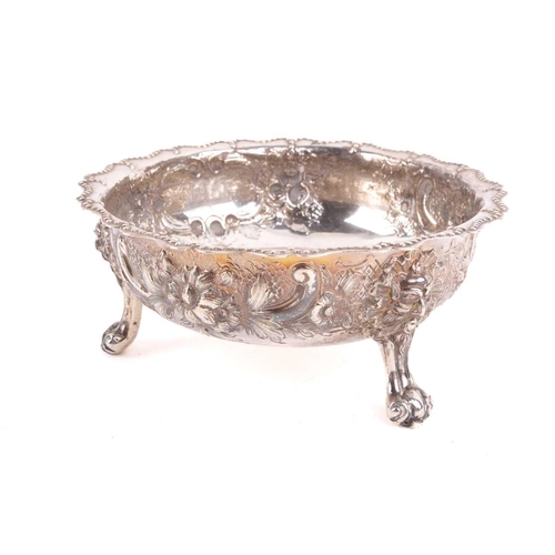 489 - A Victorian silver bowl decorated with flowers and C scrolls around a vacant cartouche, with a beade... 