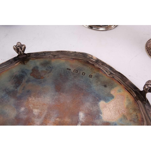 495 - A silver salver on four ball and claw feet together with three 20th-century silver mugs, the small b... 