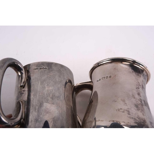 495 - A silver salver on four ball and claw feet together with three 20th-century silver mugs, the small b... 