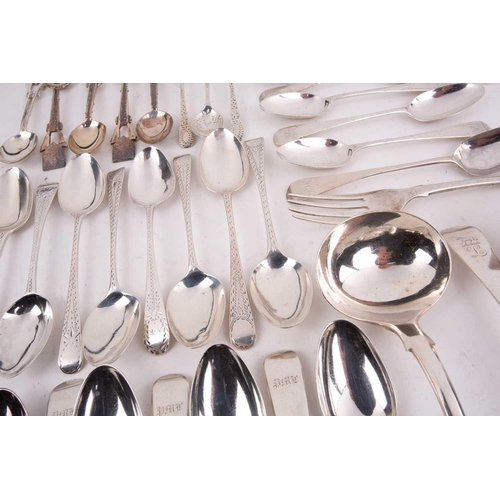 496 - A mixed quantity of silver flatware including a set of six George III tea spoons with bright cut dec... 
