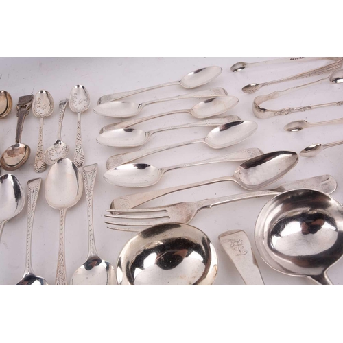 496 - A mixed quantity of silver flatware including a set of six George III tea spoons with bright cut dec... 