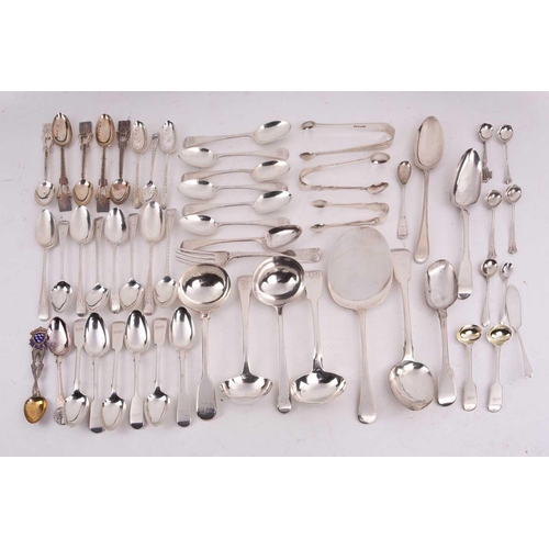 496 - A mixed quantity of silver flatware including a set of six George III tea spoons with bright cut dec... 