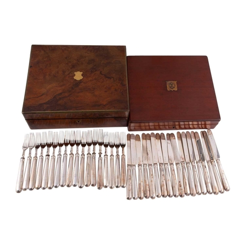 500 - A Victorian silver set of eighteen silver fruit knives and forks, the weighted handles engraved with... 